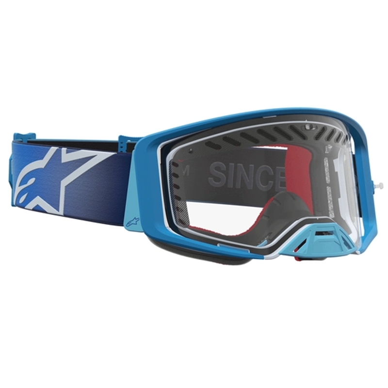 „Alpinestars Supertech Dura Air Fluid“ mėlynai sidabriniai motokroso akiniai su skaidriu plexiglasu